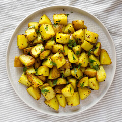 Homemade Roasted Potatoes with Mustard Seeds on a Plate, top view. Flat lay, overhead, from above.