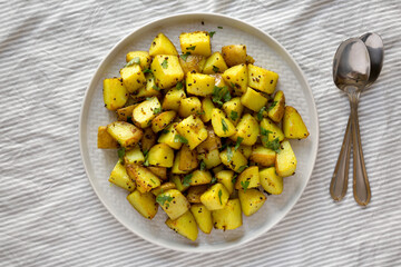 Homemade Roasted Potatoes with Mustard Seeds on a Plate, top view. Flat lay, overhead, from above.