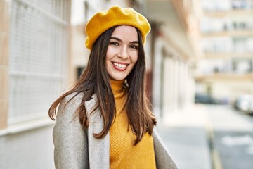 Young hispanic girl smiling happy standing at the city.