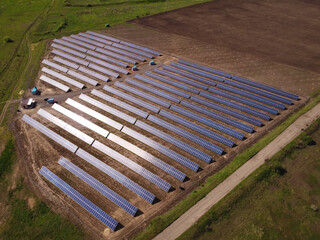 Rows of solar power plant panels from aerial view. Electrical generation station.