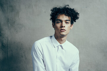 man in white shirt curly hair emotions studio modern style