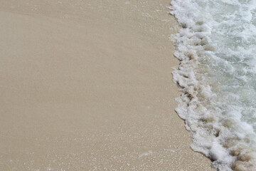 Beautiful natural scene of tropical summer sand beach background, blue ocean waves crashing on white sand beach island with copy space.