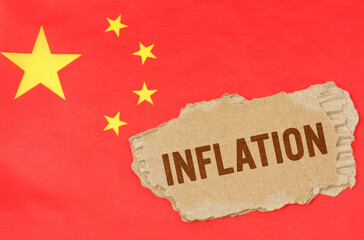 Against the background of the Chinese flag lies cardboard with the inscription - inflation