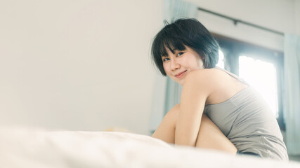 Obraz na płótnie Canvas Portrait young adult asian woman relax in bedroom on morning.