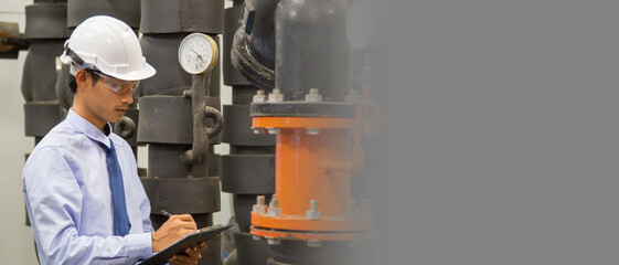 Engineer checking Condenser Water pump and pressure gauge , chiller water pump with pressure gauge.