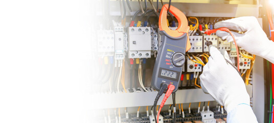 Electrician measuring voltage in distribution board, closeup