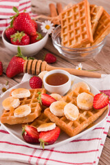 Waffles with strawberries, bananas and honey.