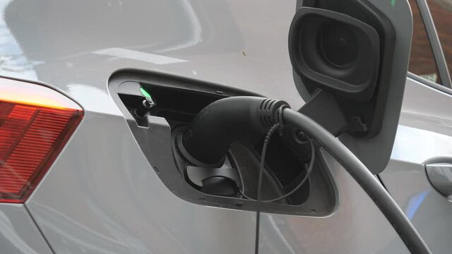 An electric car being charged on the charging station.