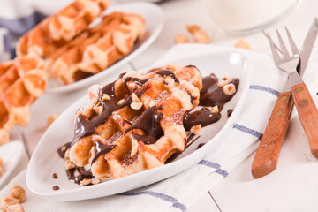 Waffles with chocolate cream and hazelnuts.