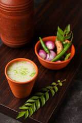 Spiced buttermilk in clay pot , chaas , chaach , moru , sambharam , curd, lassi , yogurt, cool refreshing drink for hot summer in glass , Kerala, India Sri Lanka. Flavored Indian buttermilk.	