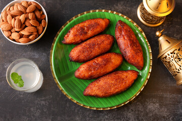 Unnakkaya , banana rolls,  popular Kerala snack for Ramadan Kareem, India, sri Lanka . Traditional Iftar food dish Malabar Muslim feast. Holy month of Ramadan. tea time snack in golden plate