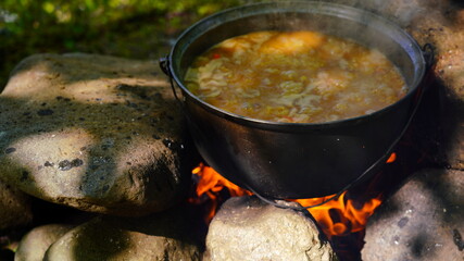 cooking lamb pilaf on a fire