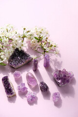 amethyst minerals set and white flowers. spa, relax concept. Healing gemstones for Crystal Ritual, spiritual practice. modern magic. Esoteric life balance concept. flat lay