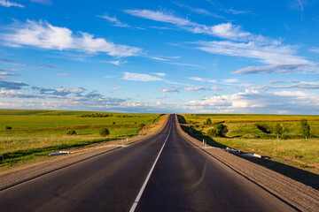 Fototapeta premium New road stretching into the distance beyond the horizon into the clouds