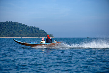 Fototapeta premium A Scenic view from Remote place in Thailand, Big mountain Landscape with tourist or local boat in Ocean 