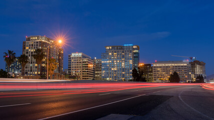 San Jose Downtown and Car Light Trails on California State Route 87 during the Blue Hour. San Jose, California, USA. - obrazy, fototapety, plakaty