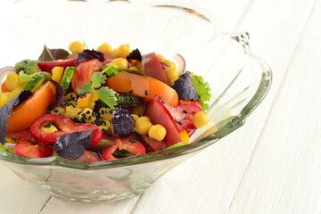 Salad with chickpeas, fresh vegetables and black sesame, copy space