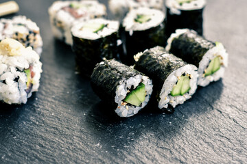 Japanese sushi food. Maki ands rolls with tuna, salmon, shrimp.Assorted sushi. Rainbow roll, uramaki, hosomaki and nigiri.  Sushi Set sashimi  served on stone slate