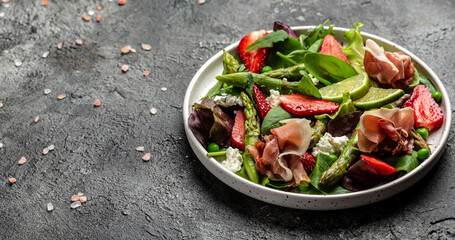 Healthy salad. green asparagus, strawberry, rocket and cottage cheese. Healthy balanced eating. Top view