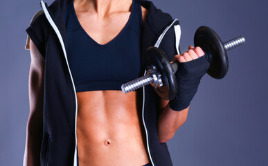 Young woman doing exercise with dumbbells