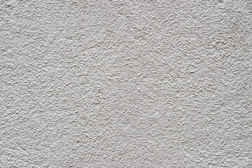 Heavily textured white and grey external plastered wall