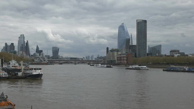 Dark dramatic clouds over Thames River in London.
