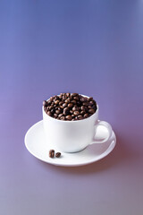 White coffee cup with coffee beans on violet  gradient background. Copy space