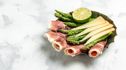asparagus, jamon, ham, prosciutto, strawberries. ketogenic diet lunch concept. Keto Paleo diet menu, top view