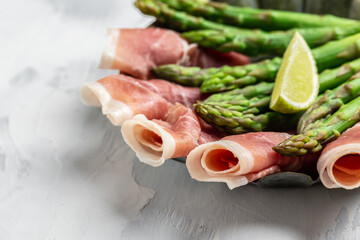 fresh green asparagus and jamon serrano, ham, prosciutto. ketogenic diet lunch concept
