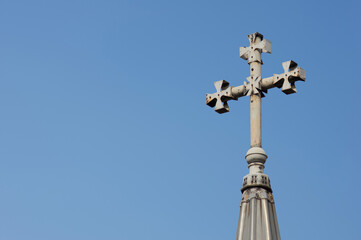 Fototapeta na wymiar Close-up of a Cross on a Christian church on blue background