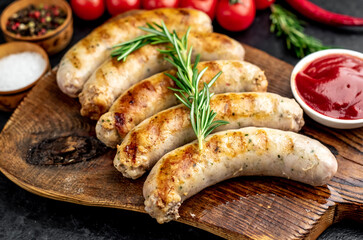 grilled sausages with spices on a stone background