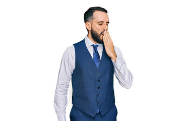 Young man with beard wearing business vest bored yawning tired covering mouth with hand. restless and sleepiness.