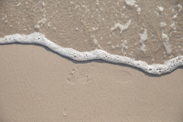 Fototapeta na wymiar Footprint in the sand on the beach