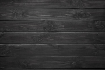 Vintage black wood background texture with knots. Wooden dark horizontal boards. Top view with copy space.