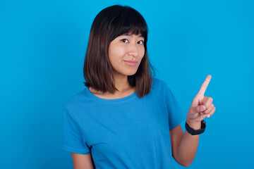 No sign gesture. Closeup portrait unhappy Young beautiful asian girl wearing blue t-shirt against...