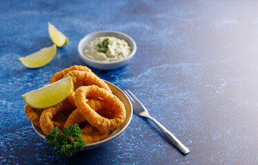 Fresh homemade calamari with homemade tartar sauce and lemon.