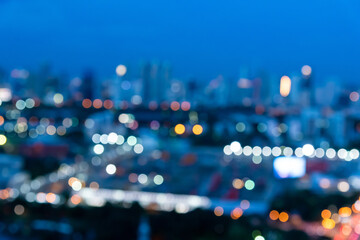 Abstract urban night light bokeh defocused of city and the office building. City and tower blurred...