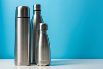 Metal water bottle on color background. Zero waste. Space for text