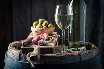 White wine and olives and cold cuts. Wine and appetizer.