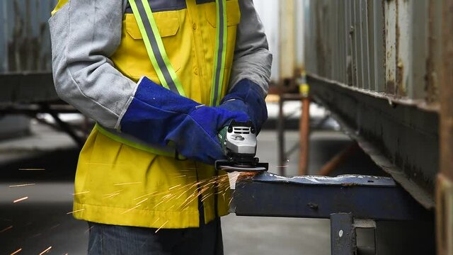 video of worker welding a part of steel in workshop near shipyard