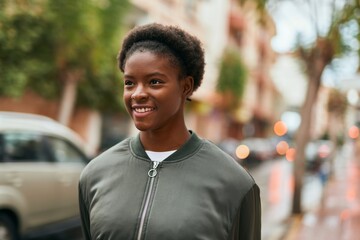 Young african american girl smiling happy standing at the city.