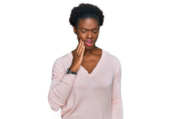 Young african american girl wearing casual clothes touching mouth with hand with painful expression because of toothache or dental illness on teeth. dentist