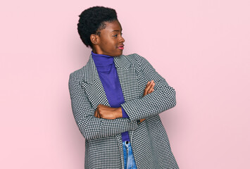 Young african american girl wearing casual clothes looking to the side with arms crossed convinced and confident