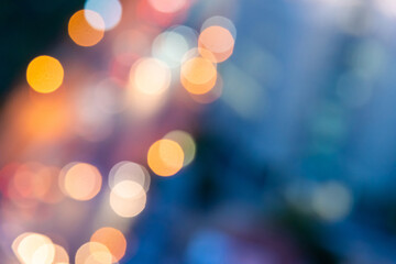 Obraz premium Abstract urban night light bokeh defocused of city and the office building. City and tower blurred background on twilight color sky. Night light of real estate as concept.