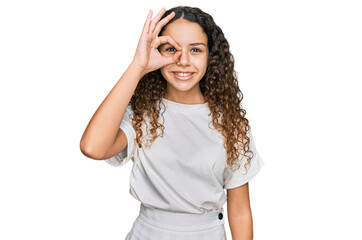 Obraz na płótnie Canvas Teenager hispanic girl wearing casual white t shirt smiling happy doing ok sign with hand on eye looking through fingers