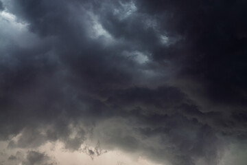Naklejka na ściany i meble Dramatic sky background with dark rainy clouds before the storm.