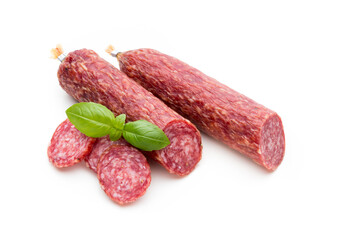 Salami smoked sausage, basil leaves and peppercorns isolated on white background.