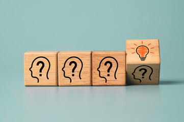 Flipping wooden cube block which print screen face with questions mark to light bulb, creative idea...