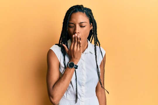 African american woman wearing casual clothes bored yawning tired covering mouth with hand. restless and sleepiness.