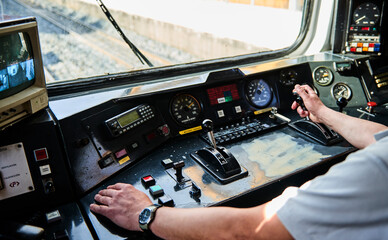 Interior view of the pilot hands and instrument panel cockpit of ancient train
